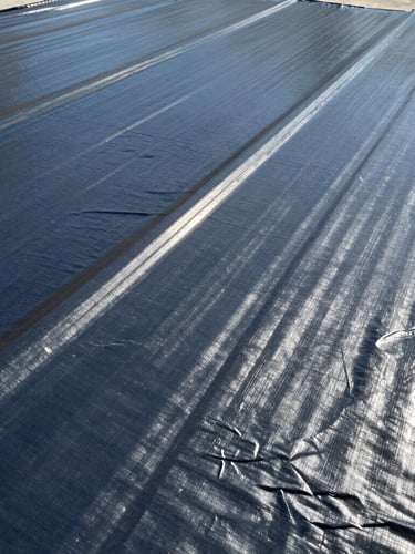 Macro shot of high-grade industrial waterproofing membranes and protective coatings, bright natural daylight highlighting material texture, 35mm