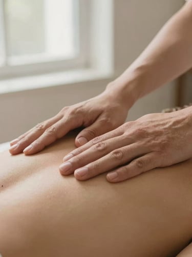 Close-up of therapeutic hands performing a gentle massage on a shoulder, warm sand and sage tones, soft natural window light, tranquil atmosphere