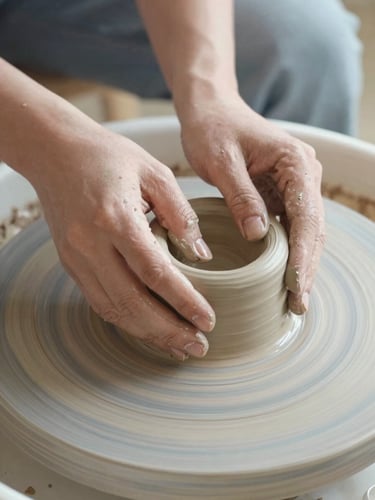 Tactile close-up of hands shaping raw clay on a potter's wheel, soft morning daylight, muted pastel tones, 35mm