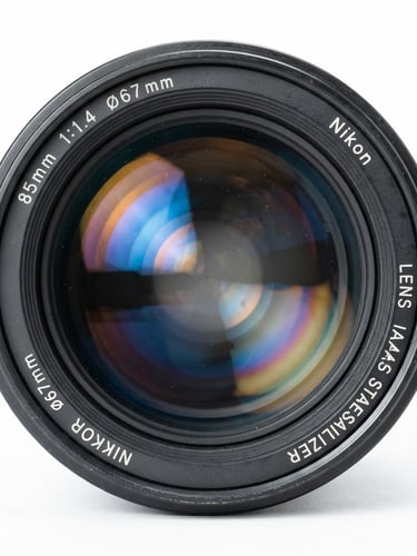 Front element of a professional camera lens, extreme macro shot showing multi-coating reflections in blue and amber, sharp focus, clean white studio background