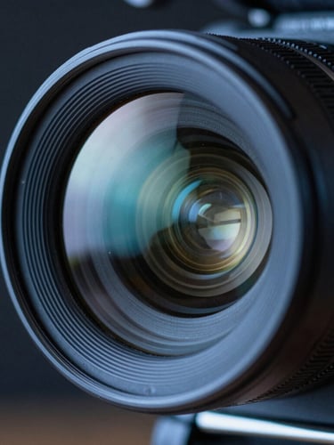 Extreme close-up of a high-end cinema camera lens, cool blue ambient light reflecting off the glass, sharp focus, dark background