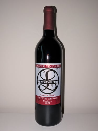 A single bottle of red wine labeled "Estate Grown Barbera"