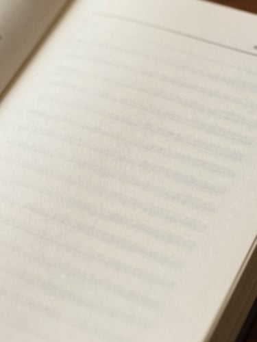 Macro flat-lay of open study guide displaying clean interior typesetting, generous margins, and elegant drop caps on warm cream paper