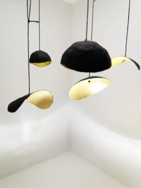 a ceiling light with a black and gold shade