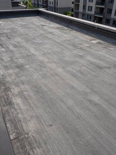 Overhead view of a large residential condominium rooftop slab under studio strobe light, concrete surface texture sharp and even, no people, no furniture