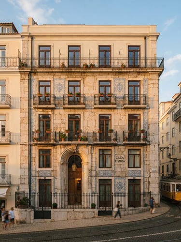 Warm editorial architectural photograph of a renovated historic building facade in Lisbon, golden-hour sunlight casting soft shadows on natural limestone, 35mm.