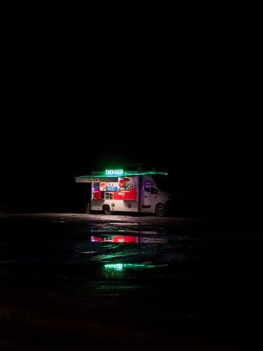 Food truck on a muddy place at night after the rain
