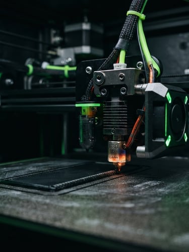 Macro shot of a high-tolerance industrial FDM 3D printer nozzle extruding black carbon-fiber filament with precision, low-key dramatic studio lighting, neon green accents, technical dark background