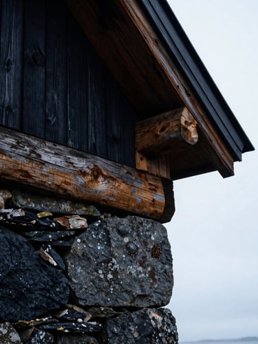 Extreme close-up of weathered dark stone and raw timber joints, overcast Nordic daylight, high contrast architectural textures