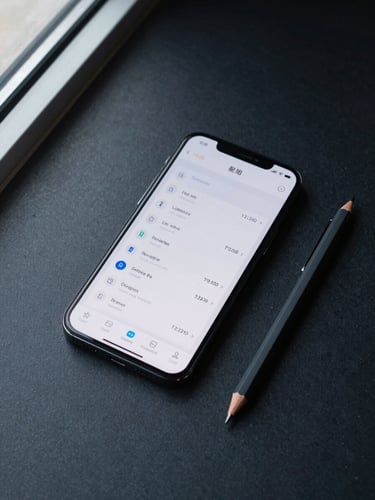 Overhead flat-lay of an Android phone on a dark matte surface, an app interface showing clean data and minimal UI visible on screen, shot under cool daylight from a high window casting sharp shadows, no clutter, only the device and a single mechanical pencil beside it