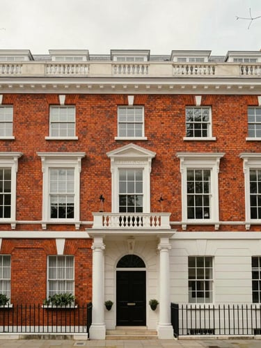Straight-on architectural view of a classic red brick townhouse in Kensington, soft overcast London daylight, desaturated heritage tones, premium editorial aesthetic