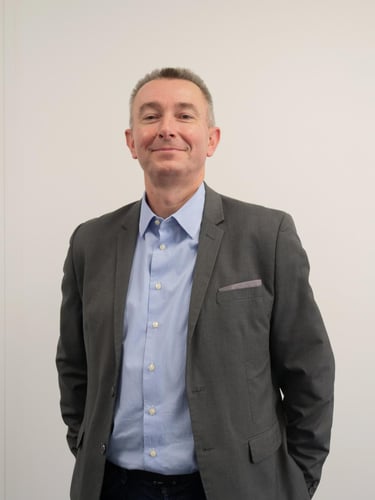 a man in a suit and tie smiling