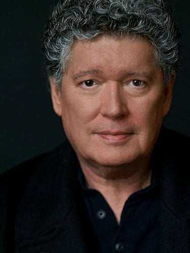 a man with a gray hair and a black shirt