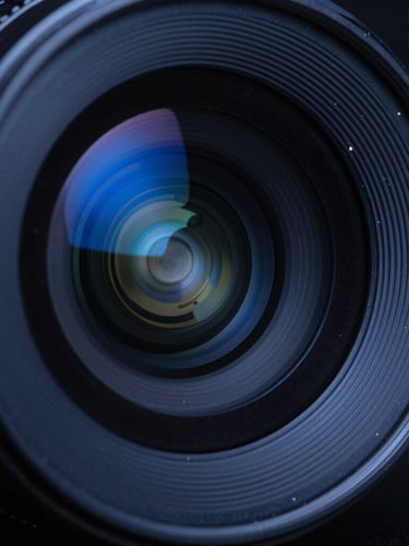 Macro shot of a high-end camera lens showing intricate reflections of electric blue studio light, dark metallic textures, 35mm