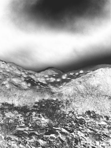 a black and white photo of a mountain scene