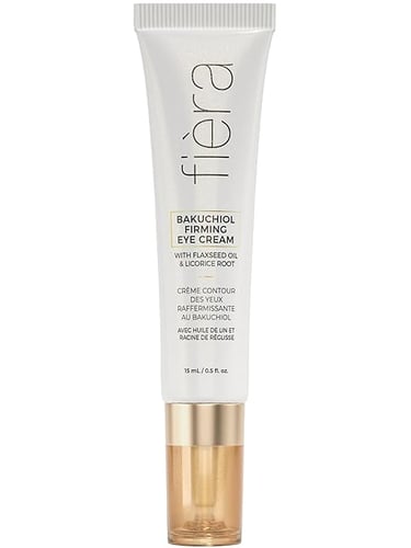 a white and gold tinted eye cream with a gold and white background