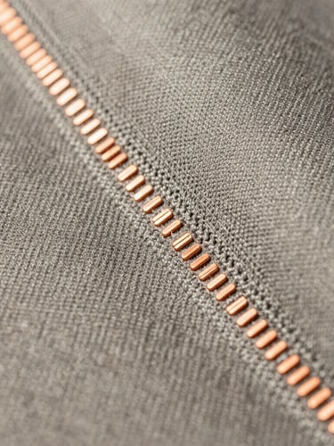 Macro studio photograph of premium technical textiles integrated with copper sensor nodes, high contrast lighting, focused on structural seams.