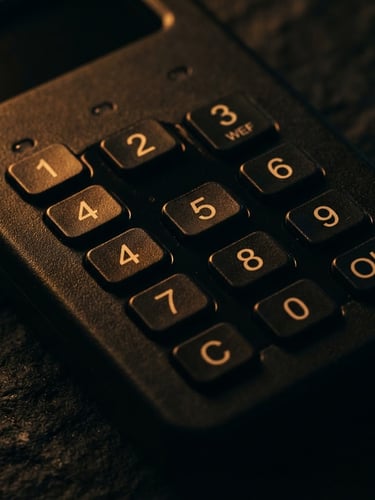Extreme close-up macro of a coldcard hardware wallet on a dark textured surface, single amber light highlighting the keypad, deep shadows, 35mm