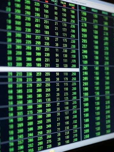 Macro shot of a high-contrast trading terminal screen displaying complex quantitative data matrices, deep obsidian background with sharp neon-green glow, cool-toned editorial photography, 35mm