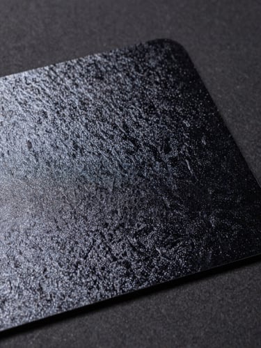 Macro shot of a velvet-laminated card with a high-gloss spot UV pattern, sharp studio lighting, emphasizing tactile contrast, deep charcoal background.