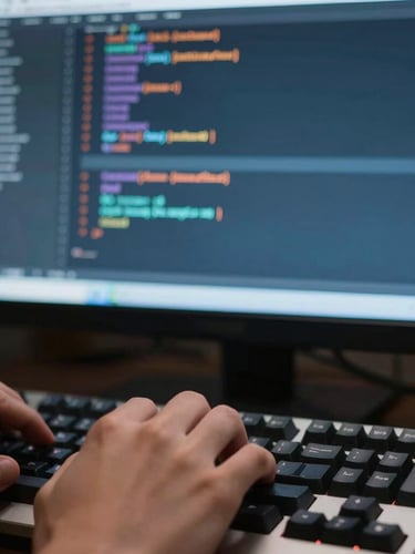 Close-up of a developer's hands typing on a mechanical keyboard, terminal screen with clean structured code in the background, 35mm.