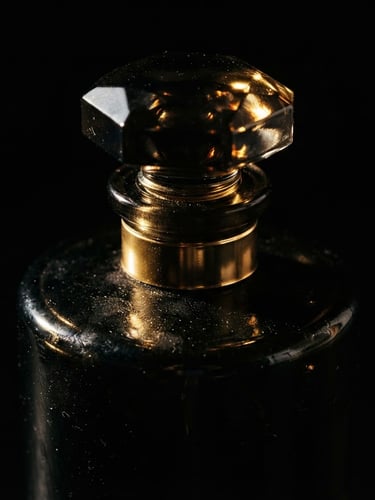 Extreme macro shot of a heavy dark glass perfume bottle catching sharp golden glints of light, deep black background, dramatic chiaroscuro lighting, 85mm lens