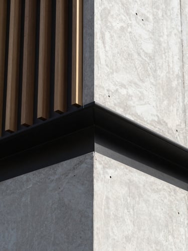 Tight details of craftsmanship on a modern timber and concrete wall interface, sharp natural daylight, architectural precision