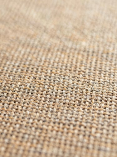Macro close-up of heavy linen weave texture, warm sand tones, soft morning daylight, 35mm