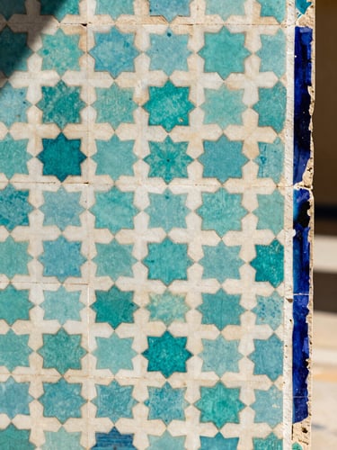 Extreme close-up of a traditional Moroccan zellige tile panel, turquoise and ivory geometric star pattern, soft diffused north-facing daylight, sharp geometric edges, right edge kissing the canvas frame