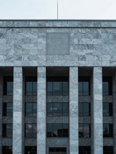 Minimalist architectural detail of a modern civic building in Ankara, cool diffused daylight, desaturated blue tones, sharp focus, 35mm lens