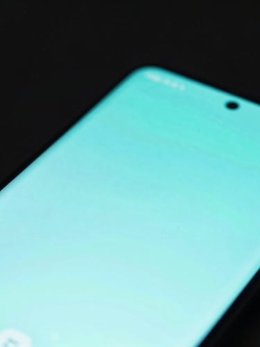 Macro shot of a sleek Android smartphone showing a fluid neon-cyan user interface, dark low-key studio lighting, sharp focus