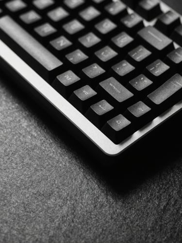 Minimalist macro shot of a mechanical keyboard on a dark slate desk, sharp geometric shadows, high-contrast black and white photography
