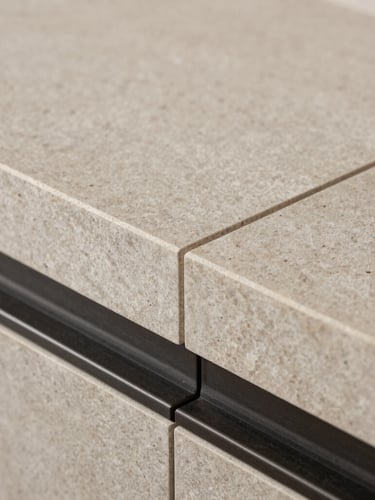 Extreme close-up of high-end architectural craftsmanship, natural brushed stone meeting dark steel trim, sharp focus, technical studio lighting