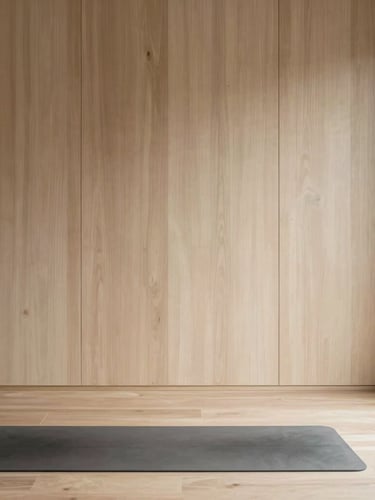 Vertical portrait shot of the clean architectural lines inside a Japandi yoga studio, focusing on soft shadows and light wood textures, a single yoga mat in the foreground, minimalist composition, natural light, 35mm lens.
