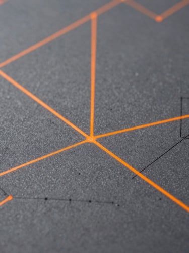Macro shot of physical architectural blueprints with digital orange laser lines projected onto them, high-contrast daylight, technical focus