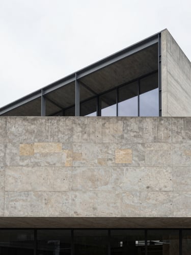 Wide architectural shot of a modern concrete and steel building facade, sharp lines, overcast daylight, minimalist composition, medium format.