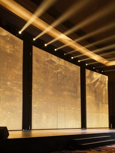 A razor-sharp architectural rendering of a luxury event stage, featuring integrated LED walls, dramatic golden up-lighting, and clean structural lines, high contrast.