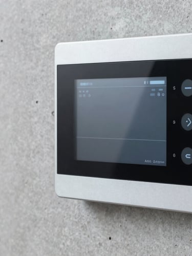 Crisp architectural photography of a minimalist home automation interface integrated into a raw concrete wall, clean metallic frame, soft technical led glow, sharp focus, 35mm lens
