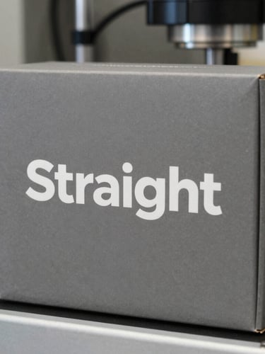 Straight-on elevation shot of a packaging system for a technical instrument, matte gray box, crisp white typography.