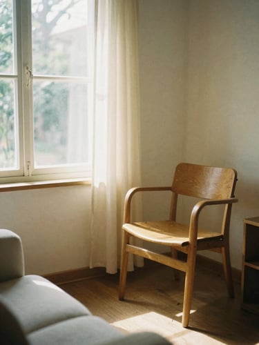 Soft natural daylight illuminating a comfortable, sunlit living room with warm sand tones, a wooden chair beside a window, 35mm photography