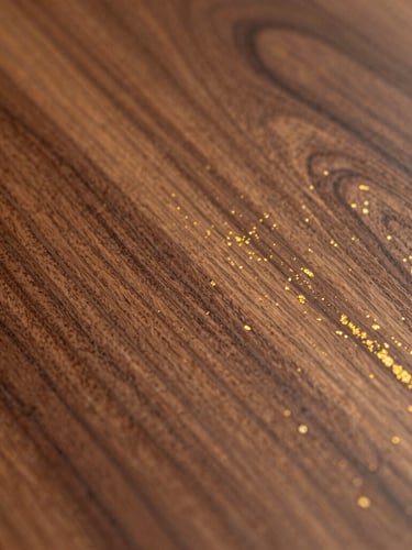 Close-up macro shot of rich walnut wood grain with a flawless satin PU-polished finish, catching warm side-light, highlighting gold flecks and organic textures, architectural digest style