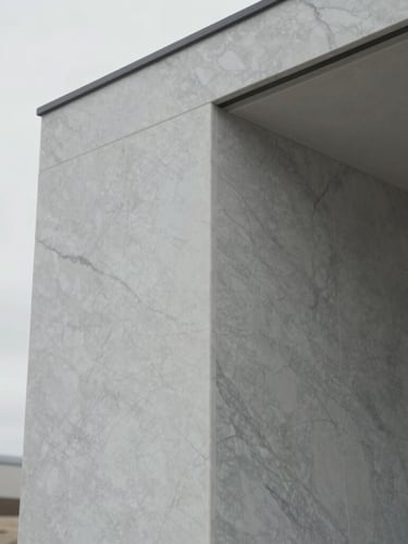 Tight detail shot of custom minimalist joinery and premium marble veining inside a modern Utah residence, soft diffused lighting, desaturated cool tones