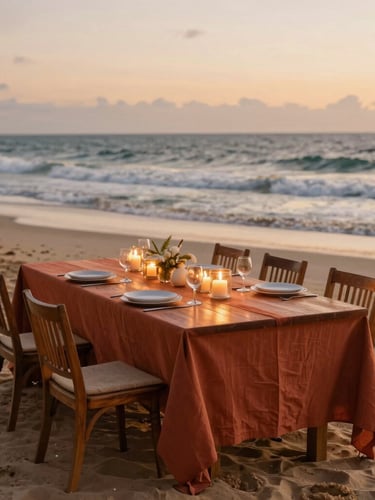 Wide-angle editorial shot of an elegant long wooden dining table set on Kiwengwa Beach at golden hour, terracotta linens, warm candlelight, ocean waves in the background, shallow depth of field, 35mm
