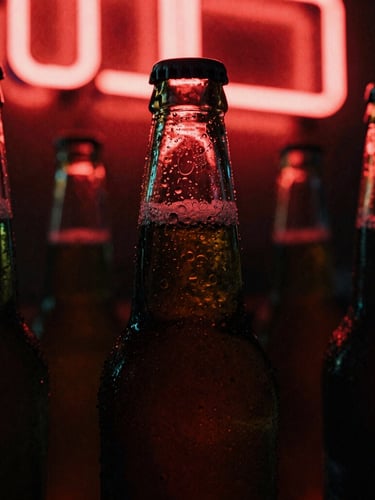 Moody close-up of condensation on cold beer bottles under a buzzing red neon sign, grainy film texture, 35mm lens.
