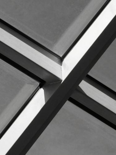 Extreme macro crop of steel and glass structural elements intersecting, high contrast charcoal and white tones, sharp focus, direct sunlight