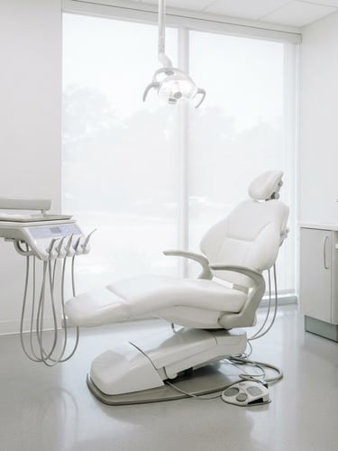 Bright high-key dental photography, sharp focus on a clean modern dental chair in a spotless white clinic room, soft light streaming from a window, professional and clinical, 35mm lens