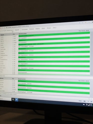 Close-up of a terminal screen showing a live deployment log with green success lines and timestamped output, cool monitor glow, dark background, no human faces