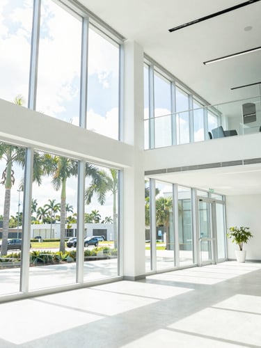 Bright modern Orlando corporate office interior, high-key natural Florida daylight streaming through glass windows, clean architectural lines, 35mm lens