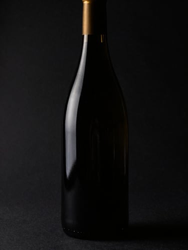 Dramatic low-key close-up of a single premium wine bottle cast in deep shadow with sharp gold rim-lighting, dark matte black background, elegant and mysterious atmosphere, 85mm lens