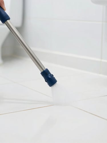 Close-up of high-pressure cleaning equipment spraying sanitizing solution onto pristine commercial restroom tile grout, bright high-key commercial lighting, sterile white and blue tones, sharp focus, 35mm